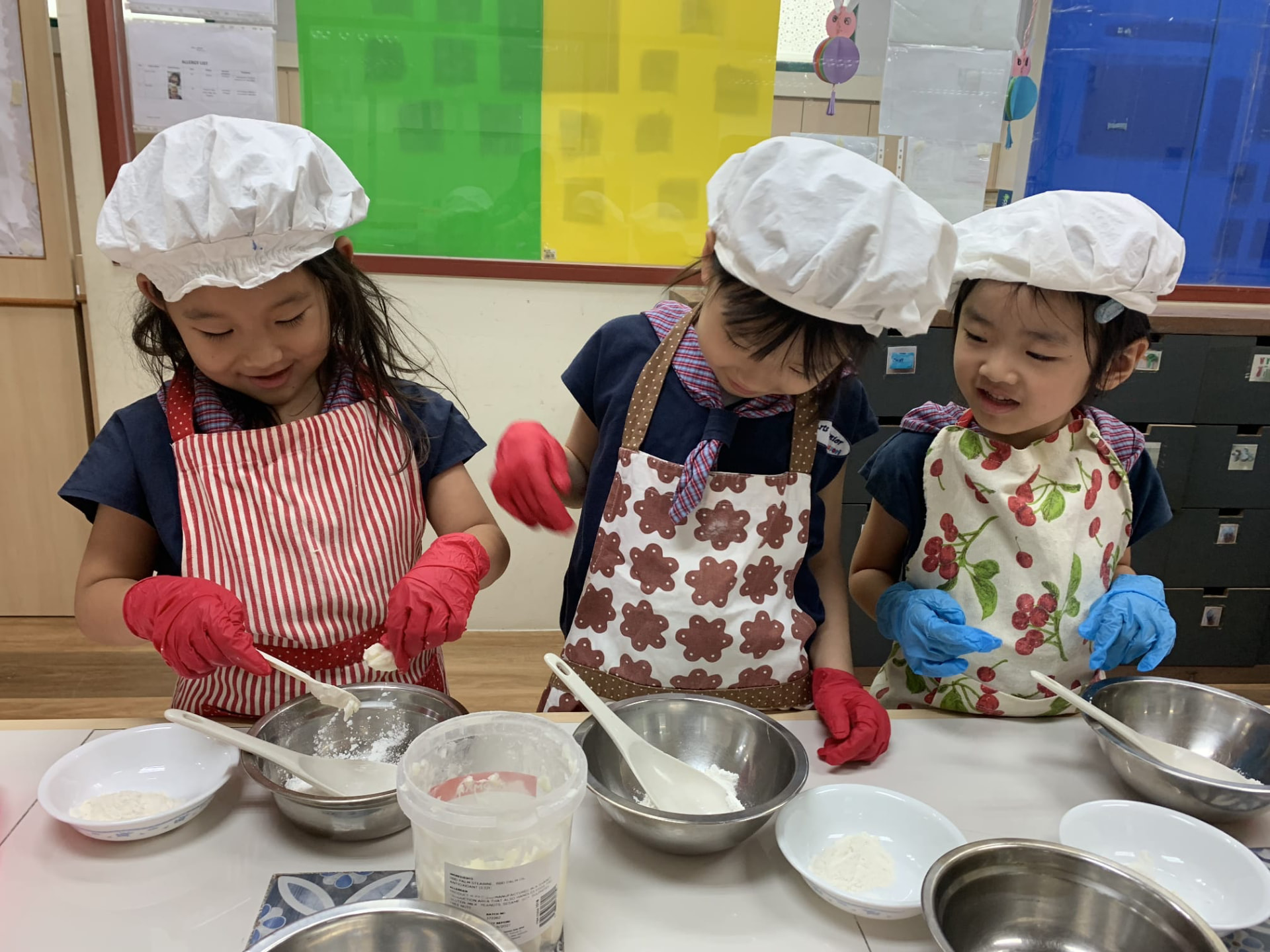 Children preparing food together in the classroom