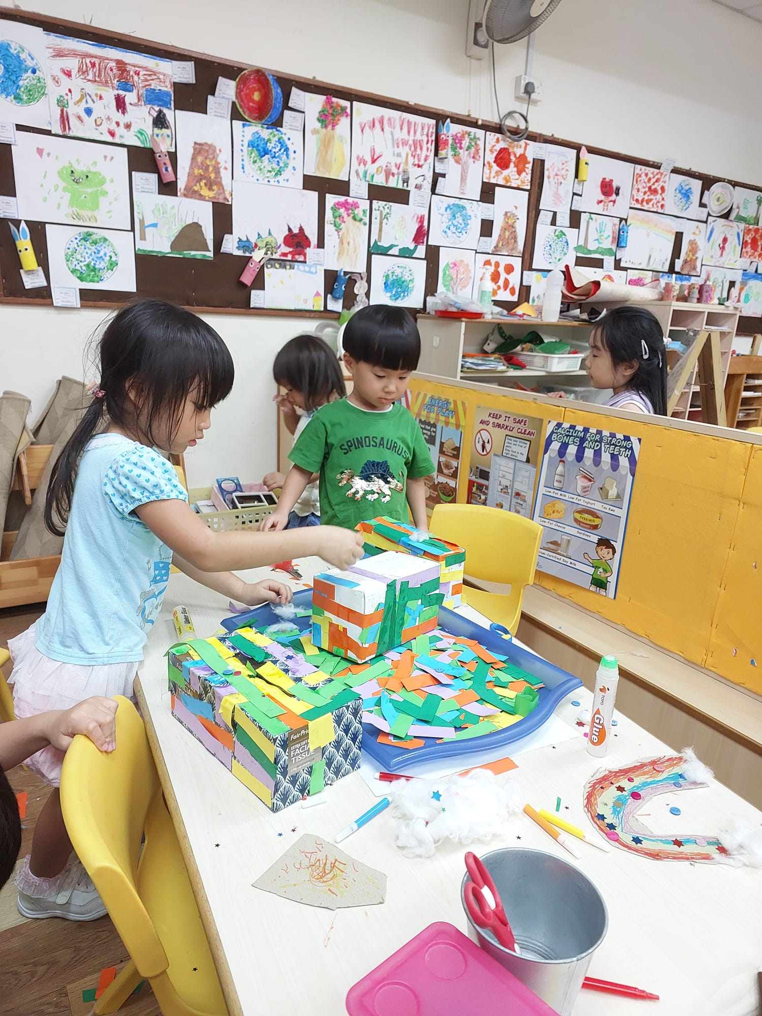 Children building with coloured paper and glue